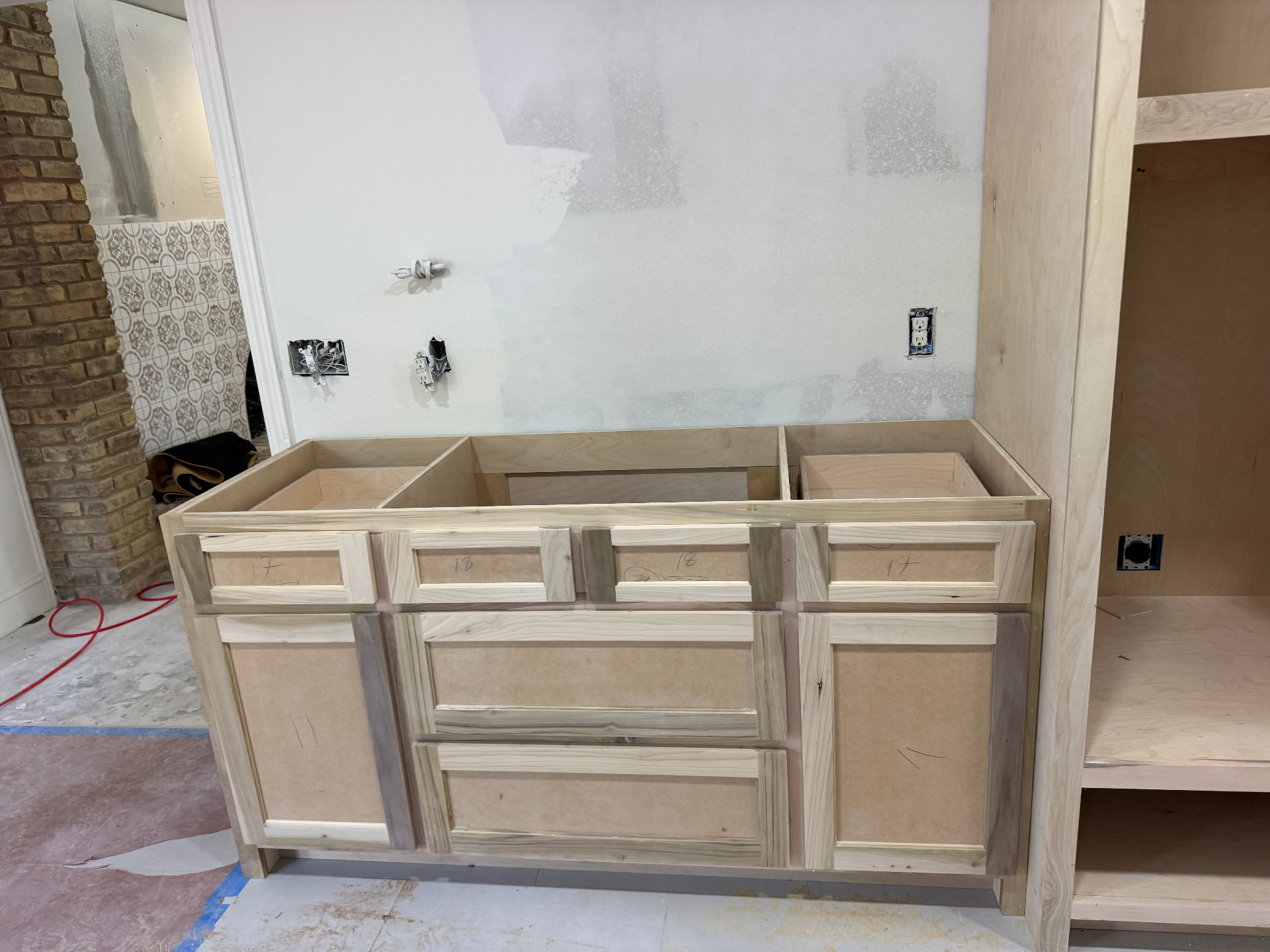 In-progress custom vanity cabinetry during fabrication and installation