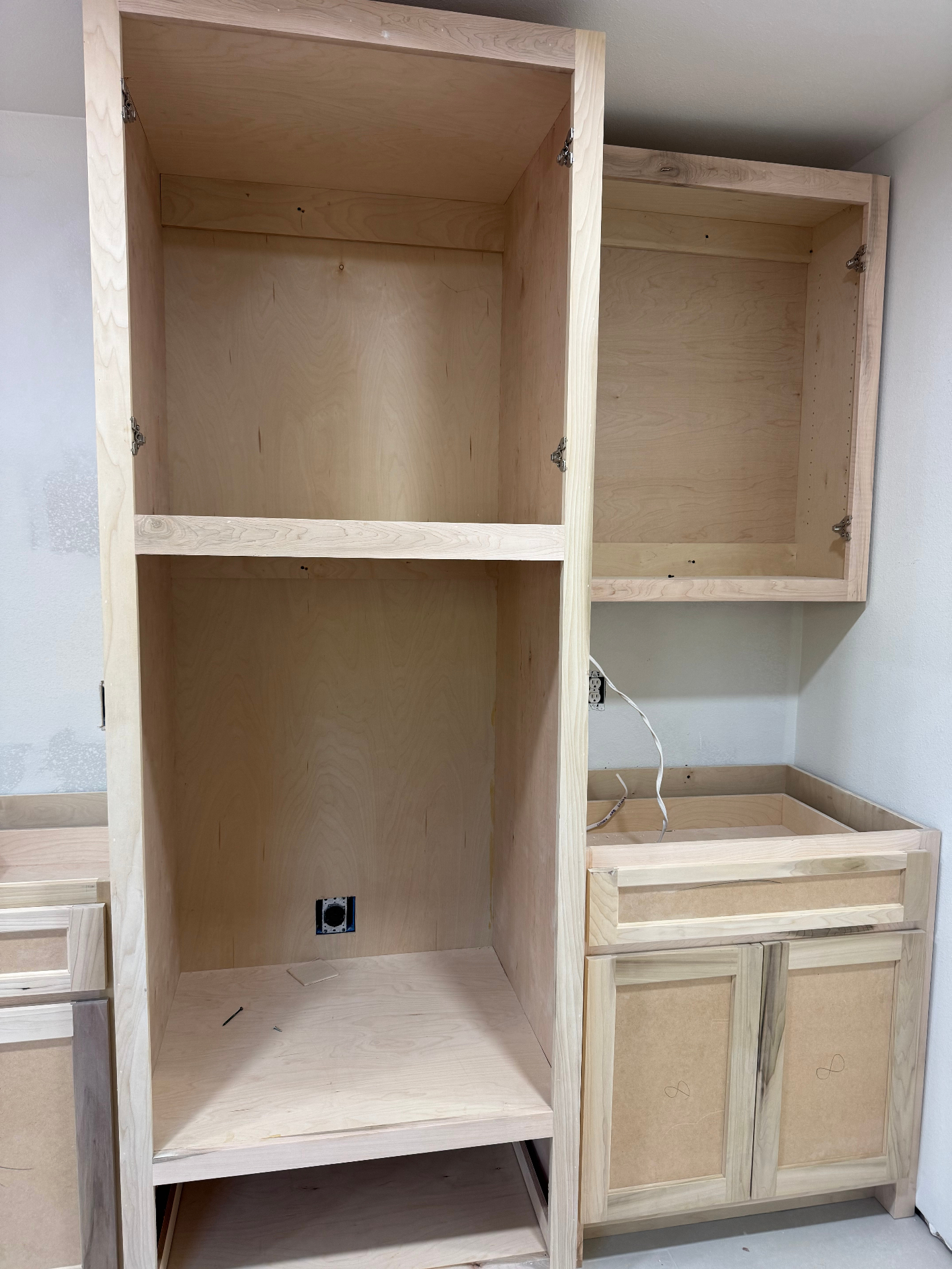 In-progress tall kitchen or utility cabinetry under construction